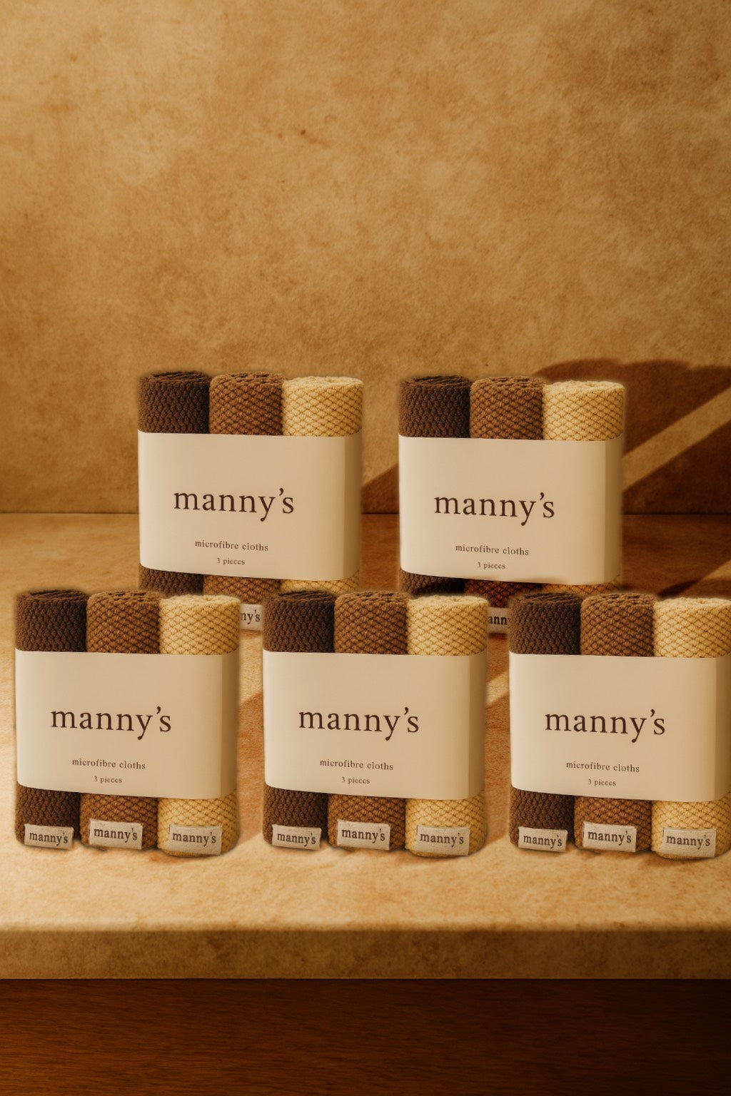 five packs of earth toned microfibre cloths sitting on a travertine bench