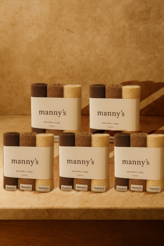 five packs of earth toned microfibre cloths sitting on a travertine bench